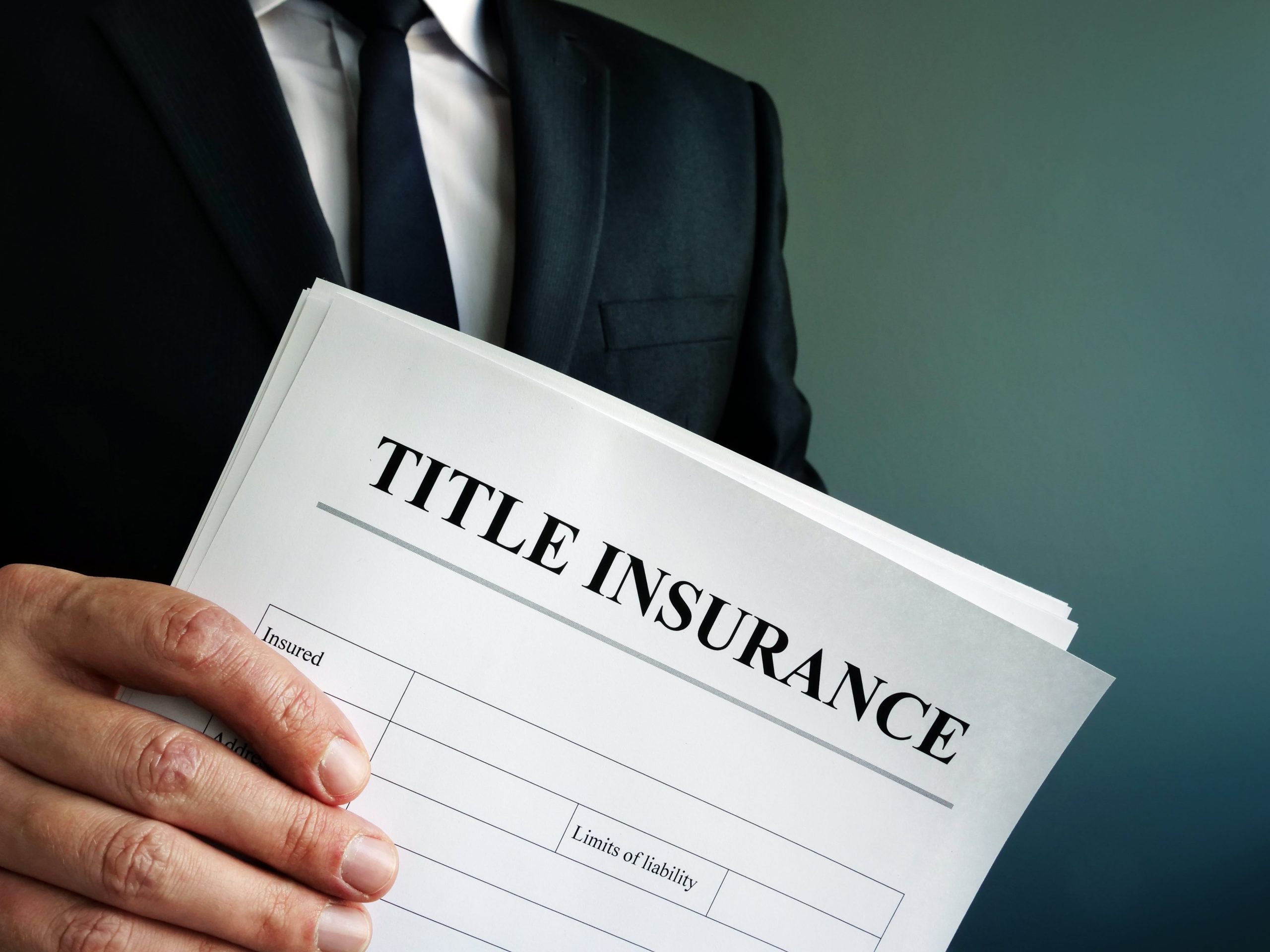 Title Insurance agreement in the hand