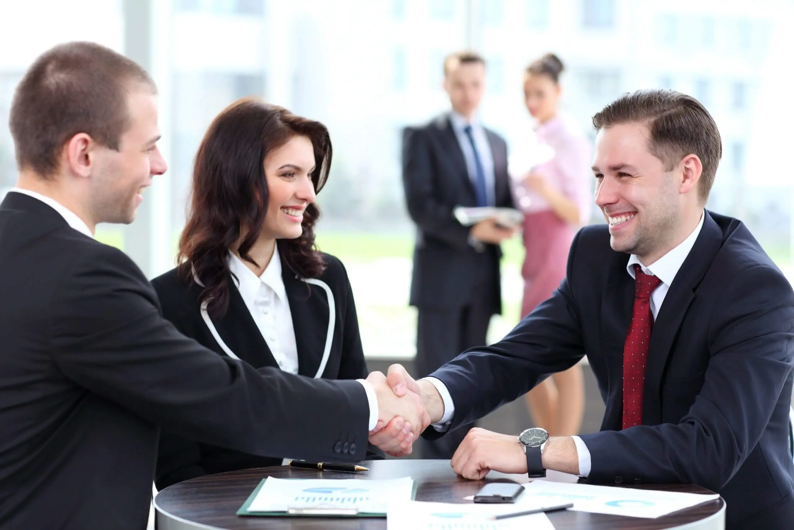 Three business professionals shaking hands